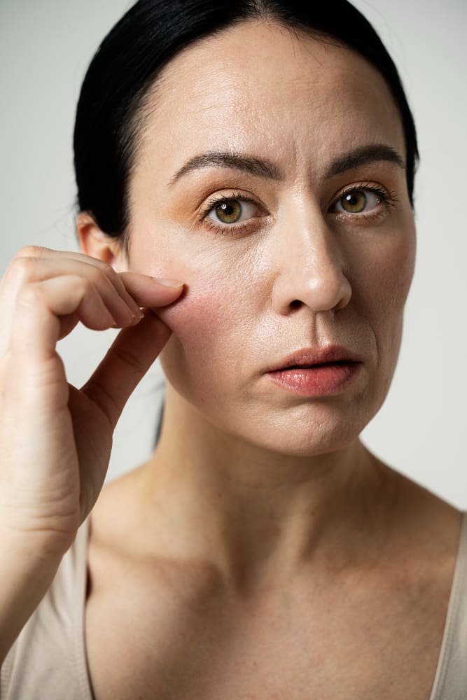 Photo of a girl analyzing her skin's elasticity